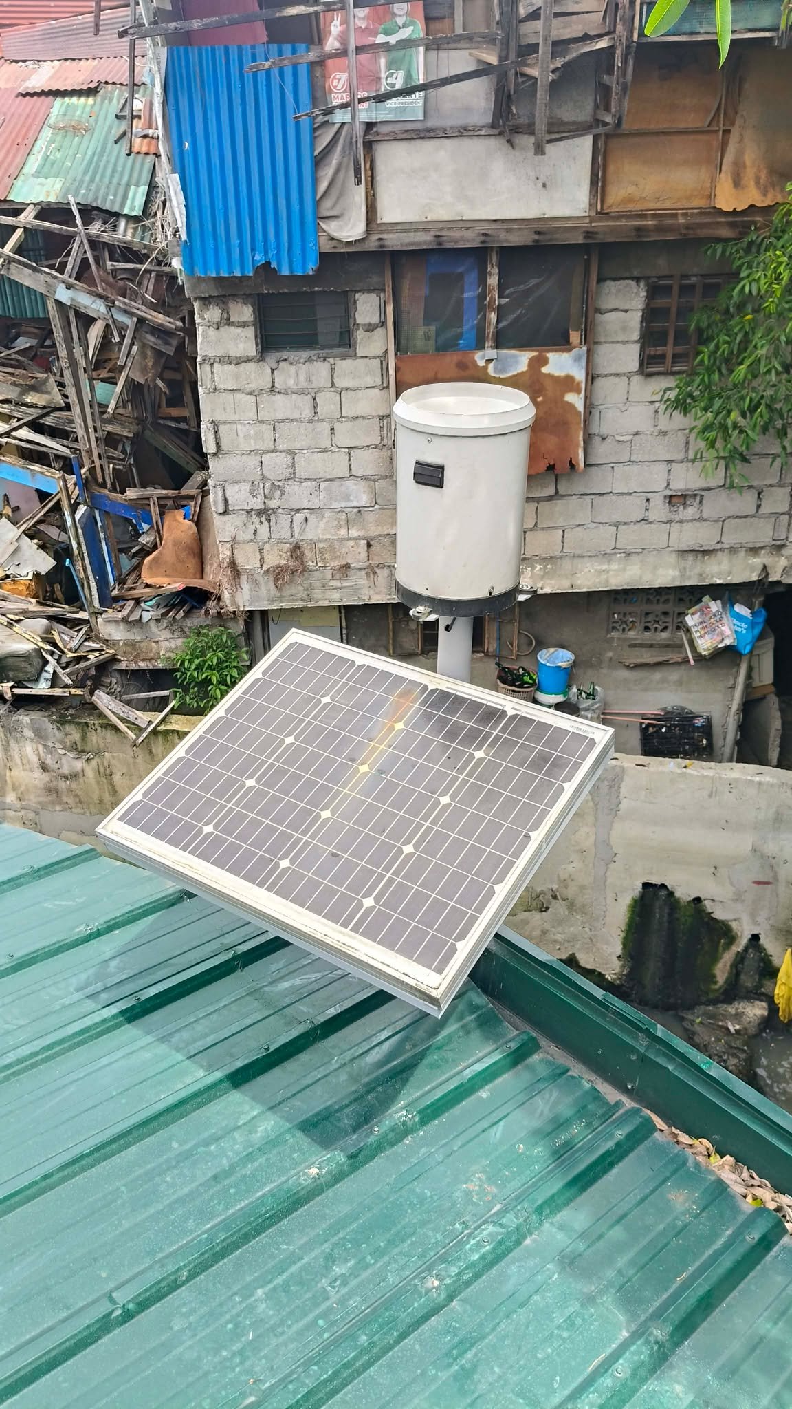 Solar-powered sensor station in a fenced enclosure in a grassy field